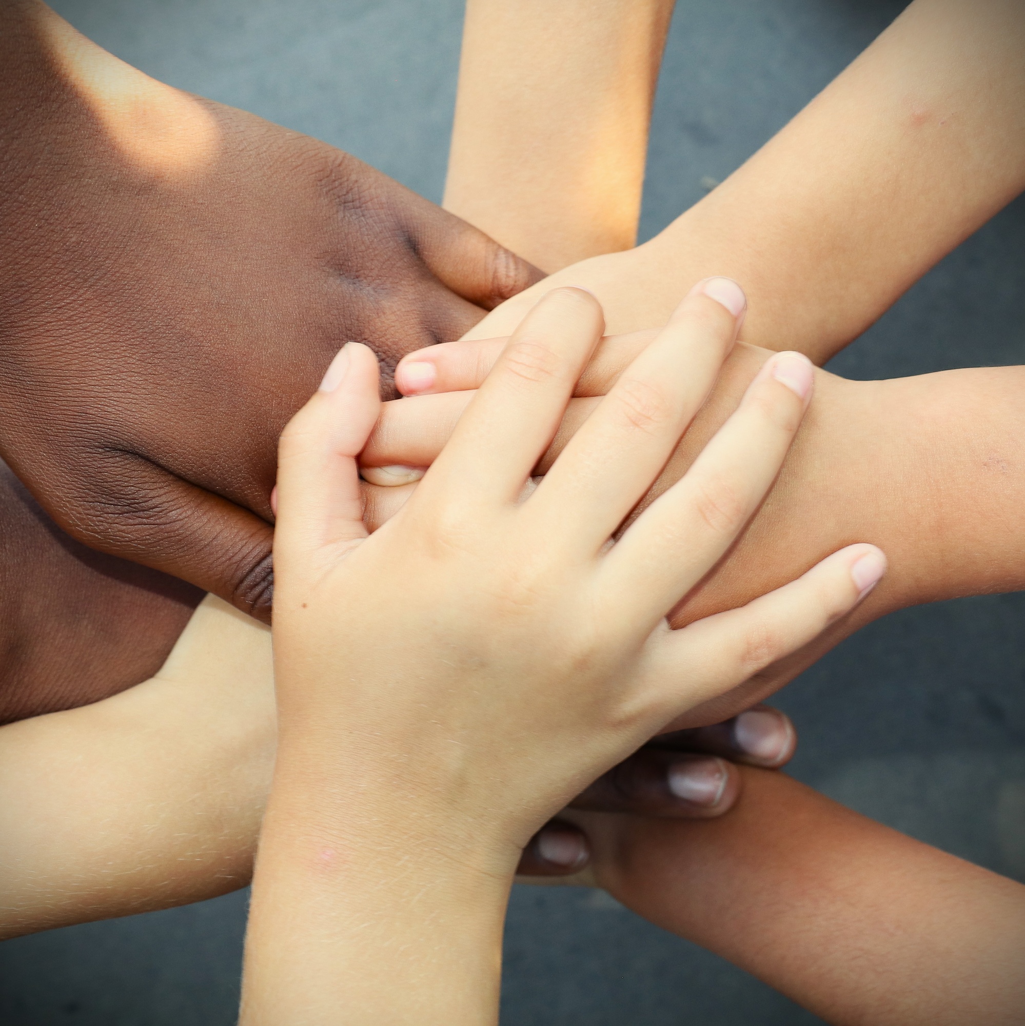 Hands of several Freemantle children on top of each other